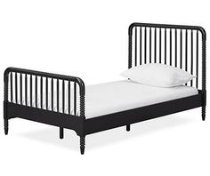 a black metal bed frame with white sheets and pillows on it, against a white background