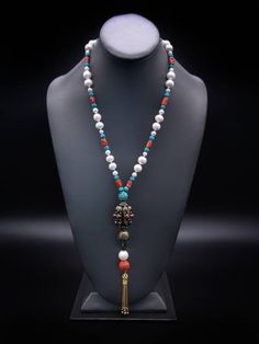 "Description and Details  Discover the beautiful Tibetan jewelry masterpiece that represents a blend of traditional and modern elements in this One-of-a-kind Deluxe long necklace!  Freshwater Pearls, Coral, and Turquoise are designed to enhance the beauty of the handmade Tibetan pendant featured in the necklace.  One-of-a-kind  Item: E 450 Freshwater Pearl  Turquoise  Tibetan Silver, Turquoise  Carved Copal Tassel: Vermeil  Clasp: Vermeil  Approx. 29\" Silk hand-knotted" Elegant Multicolor Long Necklace, Traditional Beaded Lariat Jewelry, Elegant Beaded Turquoise Pendant Necklace, Elegant Necklace With 108 Beads Pendant, Elegant Beaded Turquoise Necklace, Elegant Turquoise Beaded Pendant Necklace, Spiritual Single Strand Long Necklace, Elegant Handmade Turquoise Necklace With Round Beads, Elegant Turquoise Necklace With Round Beads For Jewelry Making