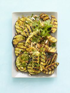 grilled eggplant and avocado salad with cilantro dressing on a white plate