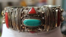 Listed above is a truly beautiful vintage, Middle Eastern, solidly carved sterling silver bangle bracelet, encrusted with turquoise, coral, yellow onyx and lapis stones. The bracelet has a security clasp which allows you to open the bracelet when putting it on. As you can see from the photos, tiny inserts of turquoise line the top and bottom rim of the bracelet. There is also a medallion of inlaid turquoise on the center inside back of the bracelet.  The circumference of the bracelet is 7 inches Traditional Turquoise Bracelets For Wedding, Bohemian Gemstone Wedding Bangle, Bohemian Silver Bracelets With Jewels, Traditional Bangle Bracelets With Natural Stones, Bohemian Round Bracelets For Collectors, Unique Carved Bracelet Jewelry, Traditional Cuff Bracelet Bangle With Natural Stones, Bohemian Silver Bracelets With Stone Setting, Vintage Bangle Bracelet With Natural Stones