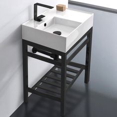 a white sink sitting on top of a black stand