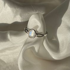 a white ring sitting on top of a white cloth