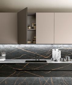 a modern kitchen with marble counter tops and cupboards in the backround area