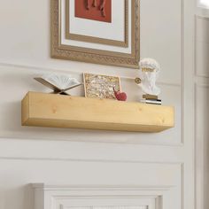 a wooden shelf with books and pictures on it