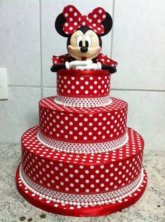 a three tiered cake with minnie mouse on top