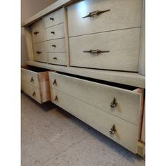 two white dressers with metal handles and drawers