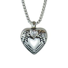 "This beautiful piece of high quality jewellery is designed to hold a tiny amount of a loved one or pet's ashes, ensuring that there is always a part of them held close to your heart. This solid 316L Stainless Steel pendant is in the shape of a heart with angel wings and a clear Czech crystal. Measuring approximately 1.8cm/0.71\" in overall height and 1.8cm/0.71\" in width. The high quality solid 316L Stainless Steel 'box' chain measures approximately 51cm (20\").  Each Pendant comes beautifully Engraved Stainless Steel Heart Pendant Jewelry, Heart Cut Birthstone Jewelry For Keepsake, Keepsake Heart Cut Birthstone Jewelry, Heart Cut Stainless Steel Jewelry Gift, Heart Cut Stainless Steel Jewelry For Gift, Nickel-free Heart Pendant Jewelry For Keepsake, Nickel-free Heart Pendant Keepsake Jewelry, Nickel-free Open Heart Keepsake Jewelry, Engraved Jewelry For Valentine's Day Keepsake