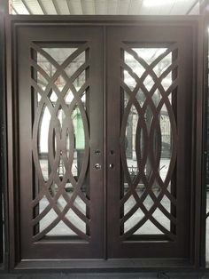 an ornate wooden door with glass panels