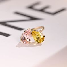 two yellow and pink rings sitting on top of a table