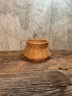 a wicker basket sitting on top of a wooden table