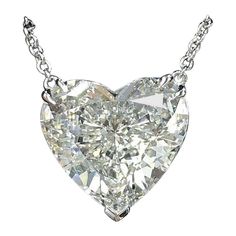 This exquisite necklace features a GIA certified 2.02 carat heart-shaped diamond pendant, elegantly set in 18K white gold. The diamond boasts a pristine D color grade and an impressive VVS1 clarity grade. With excellent polish and symmetry, the diamond dazzles with exceptional brilliance. The faint fluorescence subtly enhances its pure and radiant appearance. Suspended from a delicate white gold chain, this pendant embodies timeless elegance and sophistication. Heart Shaped Diamond Necklace, Heart Shaped Diamond Pendant, Heart Shaped Diamond Ring, Diamond Heart Pendant Necklace, Heart Shaped Pendant Necklace, Diamond Necklaces, White Gold Chains, Heart Shaped Diamond, Heart Pendant Diamond