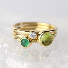 A stunning green peridot stacking ring made from solid 9ct yellow gold. Choose to wear the ring on its own, or mix and match it with other stacking rings from the Nebula collection, or why not add a sparkling Andromeda diamond ring?Peridot is a beautiful juicy green gemstone and the birthstone of August. It is one of only a few stones to come in only one colour, a lovely olive green and is said to bring a wonderful year to whoever wears it. It's warm glowing colour is a reminder of summer and of Birthstone Stacking Rings, Jewelry Making Classes, Diamond Gold Ring, Gold Stacking Ring, Gold Diamond Engagement Rings, Tarnished Jewelry, August Birthstone, Jewellery Ideas, Gold Ring Stack