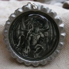 a bottle cap with an image of a demon on it