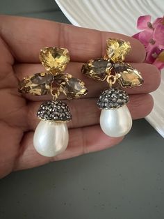 Prepare yourself for the festive season ♥️ Stylish Pearl and Crystal Earrings. The material is brass with gold plating and stones  Weight: 18 grams a pair Length: 4.5 cm Width: 2.5 cm Prong Setting Push Back Closure  Can go well with both Indian and Western wear. Gold-plated Jeweled Crystal Earrings For Party, Gold Plated Jeweled Crystal Earrings For Party, Jeweled Dangle Pearl Earrings For Parties, Gold Jeweled Pearl Earrings For Party, Jeweled Metal Clip-on Earrings As Gift, Jeweled Drop Earrings For Anniversary, Gold-plated Jeweled Earrings For Gift, Gold Plated Jeweled Earrings Gift, Gold-plated Jeweled Bridal Earrings