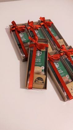 four boxes of starbucks coffee wrapped in red ribbon