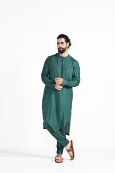 Bottle green criss cross jhaal embroidered on Modal silk with zari stitchline, pintuck and assymetrical hemline kurta. Paired with bottle green slim fit Pant Pajama. Color of the actual garment may vary due to lighting conditions during the shoot.
 

Size Chart For Men





	
	
					Men's Size Chart
		

		
		
						
				Size Chart For Men
				Custom Size Measurement Guide
			
			
				
				
				Custom Size Measurement Guide
1. Take your measurements at ease…don’t hold your breath!
2. Be a little Green Cotton Silk Kurta With Zari Work, Green Zari Work Kurta In Cotton Silk, Green Cotton Silk Kurta With Chikankari Embroidery, Green Slub Silk Kurta With Dabka Work, Green Kurta With Naqshi And Traditional Drape, Green Kurta With Naqshi In Traditional Drape, Green Slub Silk Churidar For Transitional Season, Transitional Green Slub Silk Churidar, Green Kurta With Dabka Work In Cotton Silk