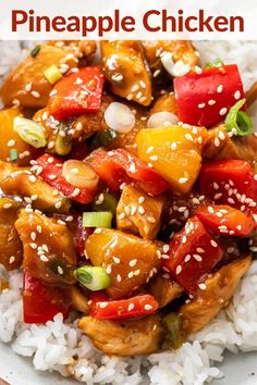 a white plate topped with chicken and veggies covered in sesame seed sauce on top of rice