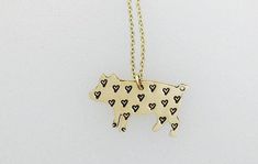 That's one precious little piggy! It's easy to fall in love with this gold-plated, heart-stamped pig pendant! Made of 14KT Gold-Filled (yellow color) Pendant measures approximately 3/4" x 1/2" Hand-stamped with tiny hearts .5 mm gold-filled cable chain with gold-filled lobster clasp Measures 18" in length Due to the handmade nature this item may vary slightly from original image See more styles by Christy Robinson Designs p.p1 {margin: 0.0px 0.0px 0.0px 0.0px; font: 12.0px Times} Jackrabbits Necklace Yellow, Pig Necklace, Pig Jewelry, Rabbit Jewelry, Vegan Jewelry, Handmade Jewel, Vegan Gifts, Eco Friendly Jewelry, Tiny Heart