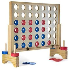 a wooden board game set with red, white and blue dots on it's sides