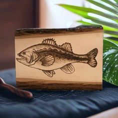 a wooden box with a drawing of a fish on it