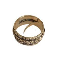 This rare Georgian gold band from around 1820 is a masterpiece, intricately hand-chased with flowers and foliage, showcasing exceptional craftsmanship. The unique feature of a hidden compartment, accessible from within, adds an intriguing element. Inside, a well-preserved lock of woven hair speaks to the sentimental nature of the era. Originating from England and unmarked but tested as 18 karat gold, the band is a size L 1/2 UK (6.25 US) with a width of 8mm. Despite its age, the ring remains in Antique Engraved Open Ring For Ceremonial Occasions, Ornate Yellow Gold Jewelry With Decorative Band, Antique Ceremonial Engraved Ring With Decorative Band, Antique Engraved Ring With Decorative Band For Ceremonial, Antique Engraved Ring With Decorative Band For Ceremonial Occasions, Ornate Gold Engraved Ring With Intricate Design, Ornate Yellow Gold Ceremonial Ring, Traditional Engraved Ring With Intricate Design For Formal Occasions, Traditional Gold Engraved Ring With Decorative Band