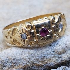 This Victorian Ring is a treasure today as it was when it was made in 1863.  The ring is hallmarked on the inside of the band and it tells it's story through those hallmarks. The ring is made out of a rich, warm buttery 18K Yellow Gold and is set with one ruby and two old mine cut diamonds. The round ruby measures 2mm round and is estimated 0.07 cts. The two diamonds on either side are natural and original to the ring. The cut of the diamonds is old mine cuts.  Jewellery throughout the Victorian Victorian Gold Engraved Collectible Ring, Antique Gold Ruby Ring With Intricate Design, Ornate Gold Engraved Ring Hallmarked, Ornate Gold Engraved Hallmarked Ring, Heirloom Gold Ruby Ring For Ceremonial Occasions, Ornate Yellow Gold Ring For Ceremonial Occasions, Ornate Yellow Gold Ceremonial Ring, Vintage Engraved Ring With Historical Design, Antique Gold Engraved Ring Hallmarked