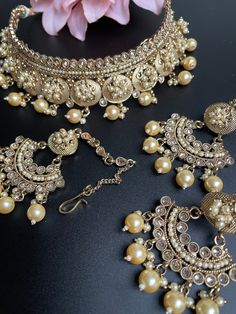 This is a beautiful Choker that comes with a set of earrings and maangtika. The stones are of beautiful quality and is a complete bridal look. It can be worn as a non bridal choker as well for any occasion. Gold Chandbali Jewelry Sets, Traditional Gold Bridal Accessories For Ceremonial Use, Traditional Gold Lehenga With Intricate Design, Gold Kundan Bridal Accessories With Tilla, Gold Kundan Bridal Accessories With Tilla Detail, Gold Jewelry Sets With Latkans For Wedding, Heavy Gold Kundan Lehenga, Gold Lehenga For Diwali Ceremonial Occasion, Ceremonial Gold Lehenga For Diwali