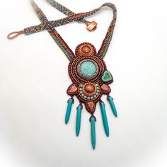 A gorgeous dream in bright and vibrant colors is this handmade unique piece: Boho beadwork necklace in turquoise and copper with a touch of purple, howlite cabochon and daggers and many tiny glass beads make a great eye-catcher that many will envy you for!!  Necklace length:  appr. 50 cm (20 inch) Pendant: 13 x 6 cm (5 x 2.3 inch) Colors: turquoise, copper, purple Material: turquoise dyed howlite, glass beads in various shapes (Miyuki, Preciosa) Clasp: toggle clasp with copper plated glass bead Artisan Beaded Turquoise Pendant Necklace, Handmade Turquoise Beaded Necklaces, Unique Handmade Turquoise Beaded Necklaces, Unique Turquoise Beaded Necklace With Pendant, Unique Turquoise Pendant Beaded Necklace, Unique Turquoise Pendant Beaded Necklaces, Turquoise Pendant Beaded Necklace, Artisan Turquoise Beaded Necklaces For Crafting, Bohemian Turquoise Pendant Beads