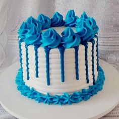 a white and blue cake with icing on it