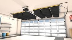 an image of a garage setting with overhead storage bins on the ceiling and two car doors open