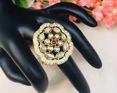 "Ivory Meenakari Kundan Ring/Meenakari Kundan/Statement Ring/Meenakari Jadau Ring/Wedding Jewelry/Pakistani Ring/Indian Wedding Ring Features: 1-Made in Brass 2-Adjustable Ring 3-Available in Gold finish 4- Made with very high quality Kundan Stones 5- Lightweight Jewelry 6- Suitable for any traditional or contemporary occasion 7- Width: 1.5\" 8- Ivory Meenakari Facebook: www.facebook.com/shoparyafashions Pinterest: www.pinterest.com/aryafashions Instagram: www.instagram.com/shoparyafashions Twit White Stone Work Wedding Gift, Festive Meenakari Temple Jewelry Ring, Festive Temple Jewelry Rings With Meenakari, Ceremonial Temple Jewelry Ring With Meenakari, Festive Meenakari Rings, Traditional Hand Set Rings For Marriage, Intricate Design Ring For Festivals, Traditional Hand-set Rings For Marriage, Traditional Marriage Rings With Intricate Design