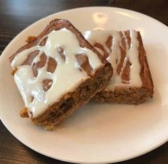 two pieces of cake sitting on top of a white plate