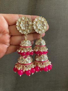 If you love Jhumkas, these earrings with double jhumkas are the perfect pair for your next traditional outfit! Wedding Bridesmaid Outfit, Pink Jhumka, Kundan Jhumkas, Festival Jewellery, Earrings Kundan, Hot Pink Earrings, Earrings Aesthetic, Indian Festival, Kundan Earrings