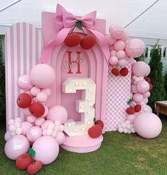 a pink birthday party with balloons and decorations