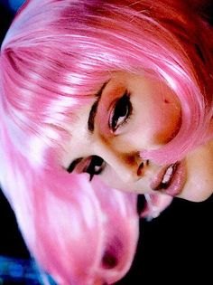 a woman with pink hair and black eyes