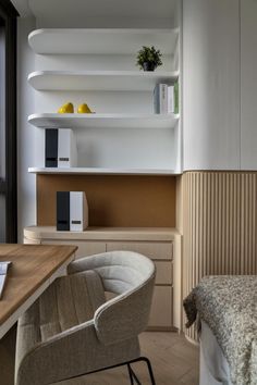 a bedroom with a bed, desk and shelves on the wall next to each other