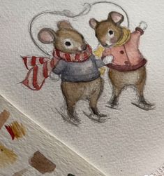 two brown mice wearing sweaters and scarves on their backs, one holding a flag