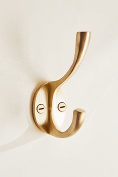 a gold door handle on a white wall