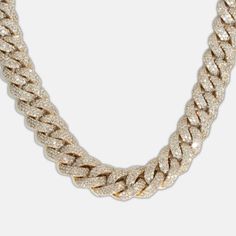 Make a lasting impression with the 13mm Iced-Out Cuban Link Chain, a bold and luxurious statement piece adorned with 41 carats of premium natural diamonds. Each diamond is graded G+ in color for radiant near-colorless brilliance and VS in clarity for exceptional purity. The diamonds are meticulously hand-set along the robust 13mm Cuban links, creating a dazzling iced-out finish that radiates elegance and sophistication. Crafted from durable 10k solid gold, available in yellow, white, or rose gol Luxury Diamond Chain Ring, Iced Out Cuban Link Diamond Necklace In White Gold, Luxury Chain Diamond Necklace For Anniversary, Gold Iced Out Round Diamond Necklace, Luxury Link Diamond Necklace, Luxury White Chain Link Necklace, Luxury Iced Out Link Chain Necklace, Luxury White Cuban Link Necklace, Luxury Iced Out Yellow Gold Necklace