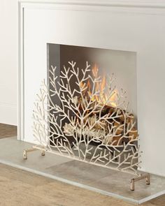 a white fireplace with a fire in it