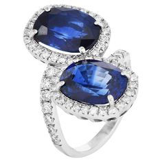 Discover the exquisite beauty of this Vintage Sapphire and Diamond Halo Bypass Engagement Ring. Perfect for those who cherish sophisticated elegance with a splash of vibrant color, this ring is an unforgettable choice for a proposal. Luxurious jewelry design. This ring features two natural Virbant blue oval sapphires, both sapphires are from Madagascar, totaling approximately 10.88 carats, encircled by a halo of 61 natural round diamonds. Sapphire measures approximately 11.77mm x 9.16mm x 5.54mm and weighs 5.29 carats  the other measures 11.9mm x 8.95mmx 5.55mm and 5.59 carats each surrounded by round diamonds, approximately 1.83 carats VS clarity, G-H color, set in premium platinum. The beautiful bypass style on an accent band is a statement ring, sized at 6.75(sizable). Two GIA Lab Repor Bypass Engagement Ring, Luxurious Jewelry, Colored Stone Rings, Vintage Sapphire, Color Stone, Gem Stone, Diamond Halo, Crystals Minerals, Sapphire Diamond