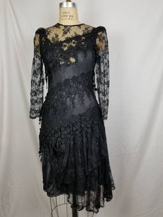 Good vintage condition Black lace Lace slip underneath 34 bust 32 waist 38 hip Has some stretch Sleeve 24 15 shoulders Fitted Scalloped Lace Evening Dress, Fitted Lace Evening Dress With Scalloped Detail, Fitted Lace Evening Dress With Scalloped Lace, Fitted Lace Patchwork Evening Dress, Fitted Lace Patchwork Dress For Evening, Fitted Lace Dress With Lace Trim For Night Out, Lace Dress With Fitted Bodice For Evening, Fitted Lace Dress With Lace Patchwork For Evening, Fitted Lace With Lace Trim For Night Out