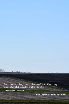 an airplane flying in the sky over a field