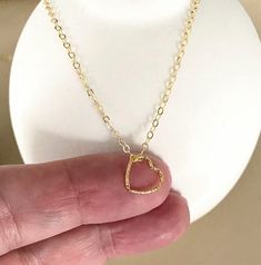 This tiny floating 14k gold filled open heart charm necklace is finished with a delicate chain and lobster claw clasp.  The necklace is available in customizable lengths from the drop down menu at check out. The heart charm is approximately 10mm.  It's wonderful on its own or layered with other necklaces.  A sweet gift for bridesmaids, mom on mother's day or a special woman on any occasion!  You may also like to  check out more of my necklaces here: http://etsy.me/2kMdyB0 Free first class USPS shipping within the USA. Minimalist 14k Gold Filled Open Heart Jewelry, Simple Gold Charm Necklace For Valentine's Day, 14k Gold Filled Charm Necklace For Valentine's Day Gift, Simple Gold Necklaces For Valentine's Day, Delicate 14k Gold Filled Heart Necklace For Valentine's Day, Delicate 14k Gold Open Heart Charm Necklace, Minimalist Open Heart Charm Necklaces For Mother's Day, Minimalist Open Heart Charm Necklace As A Gift, Gold Minimalist Open Heart Charm Necklace