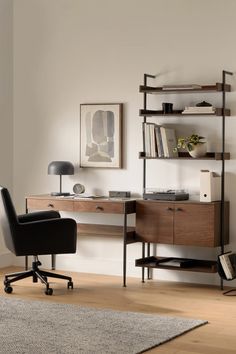 an office with a desk, chair and bookcase in the middle of the room