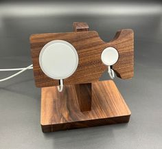 a wooden object with two white plates attached to it's sides on a table