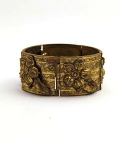 Vintage MCM bracelet in brass with flowers and leaf design. 1960's. The bracelet is in good vintage condition. Measures about 7 inches and about 1 1/4 inches wide. Please visit our Etsy store for similar items at http://www.etsy.com/shop/MarleysOnMain As with all vintage and antique jewelry, this is a previously used piece and will show some signs of wear. Please review our shop policies.Jewelry Vintage jewelry Vintage Metal Bracelets For Weddings, Antique Bronze Bracelet For Wedding, Antique Gold Bracelet With Antique Finish, Vintage Brass Bracelet With Intricate Design, Vintage Bronze Bracelets For Formal Occasions, Vintage Metal Bangle For Wedding, Vintage Bronze Bracelet For Formal Occasions, Vintage Bronze Bracelets For Wedding, Vintage Gold Bracelets For Ceremonial Occasions