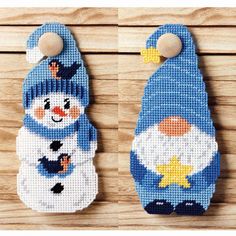 two snowmen with hats and scarfs are shown on a wooden surface, one is made out of plastic