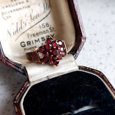 This elegant antique style gold and garnet ring would make a wonderful gift for that special someone. Set in 9 ct solid rosey yellow gold featuring 13 deep red natural garnets in a flower design. Fully British Hallmarked. INTERNATIONAL BUYERS - please read the shipping information below. Follow us on Instagram for all our latest pieces and first Dibs! They don't all make it to our Etsy store: https://www.instagram.com/mooreperfectpieces/ Fully British Hallmarked - 375 hallmark,  denoting solid 9 Vintage Garnet Birthstone Ring In Yellow Gold, Vintage Yellow Gold Garnet Birthstone Ring, Vintage Garnet Birthstone Promise Ring, Antique Garnet Promise Ring, Vintage Gold Garnet Birthstone Ring, Vintage Garnet Birthstone Rings, Vintage Garnet Promise Ring, Vintage Garnet Cluster Ring As Gift, Vintage Garnet Birthstone Ring For Anniversary