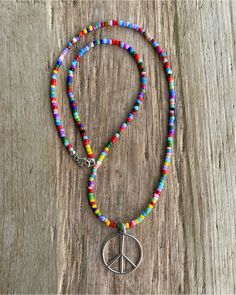 Spread good vibes wherever you go with this delightful peace sign necklace, handmade just for you. Crafted from gleaming sterling silver, the peace sign pendant hangs from a vibrant 16" necklace strung with colorful hippie love beads. https://kathybankston.com/products/peace-sign-necklace-with-hippie-love-beads Adjustable Multicolor Charm Necklaces Nickel Free, Adjustable Multicolor Nickel-free Charm Necklaces, Adjustable Charm Necklaces With Colorful Beads For Festivals, Adjustable Charm Necklace With Colorful Beads For Festivals, Adjustable Colorful Beads Charm Necklaces For Festivals, Adjustable Colorful Beads Charm Necklace For Festival, Bohemian Peace Sign Necklace For Gift, Silver Hippie Beaded Necklace For Festivals, Colorful Hippie Round Bead Jewelry